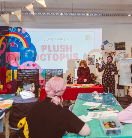 A workshop facilitator presenting about making a plush octopus for beginners